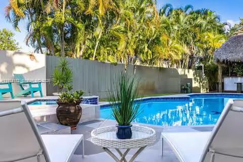 6140 Southwest 56th Court Davie, FL 33314 - Photo 62 of 69 Resort-style pool with palm trees and poolside seating!