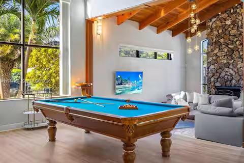 6140 Southwest 56th Court Davie, FL 33314 - Photo 10 of 69 Paradise meets pool hall in this stunning game room with tropical views and a championship-worthy table!