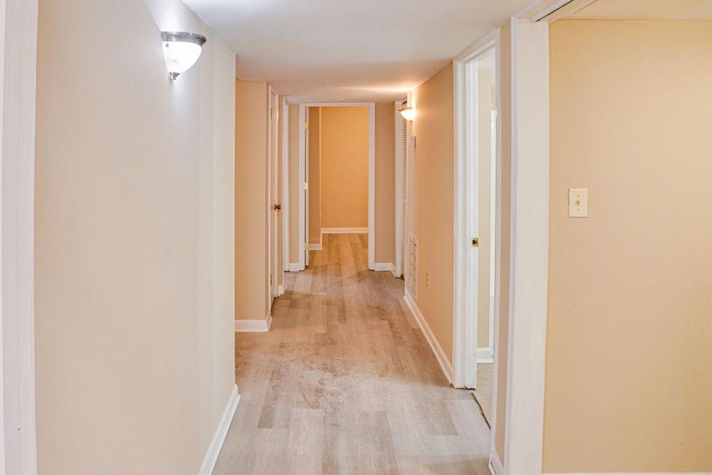 220 Winding Stream Trail Hampton, GA 30228 - Photo 11 of 35 a view of a hallway with wooden floor