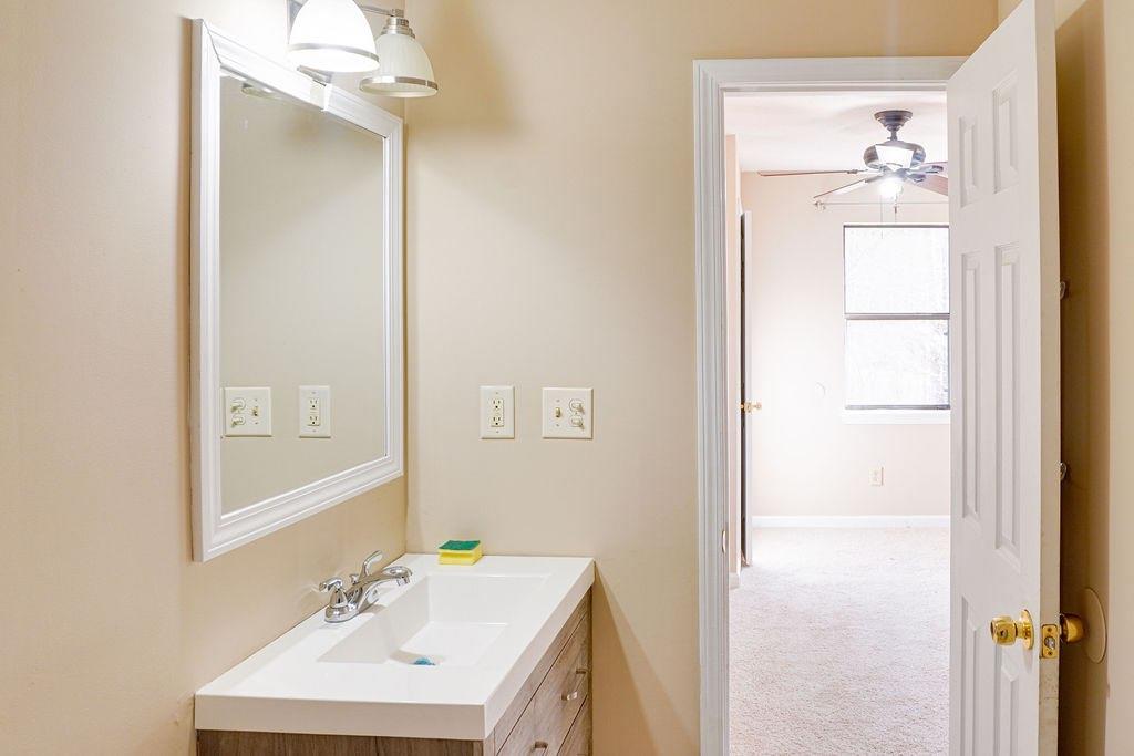 220 Winding Stream Trail Hampton, GA 30228 - Photo 14 of 35 a bathroom with a sink and a mirror