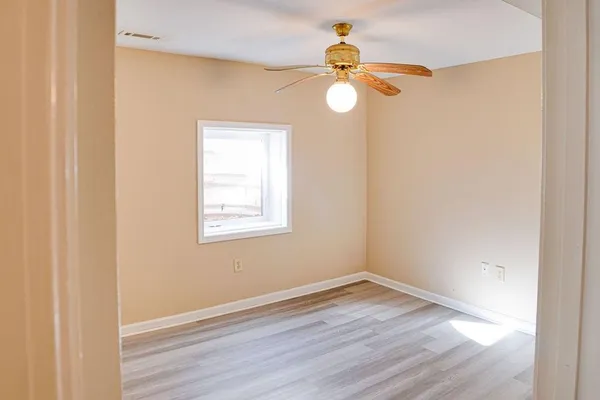 wooden floor in an empty room with a window