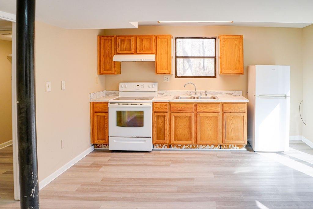 220 Winding Stream Trail Hampton, GA 30228 - Photo 23 of 35 a kitchen with a stove a sink and a window