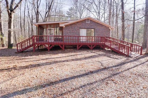 a view of a house with a yard and wooden fence