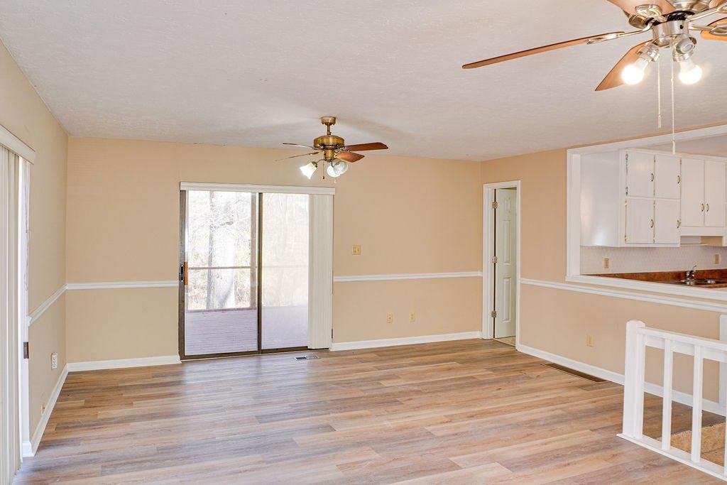 220 Winding Stream Trail Hampton, GA 30228 - Photo 5 of 35 a view of an empty room with wooden floor and a window
