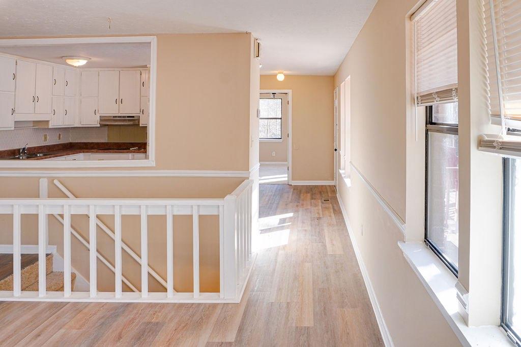 220 Winding Stream Trail Hampton, GA 30228 - Photo 6 of 35 a view of a kitchen with wooden floor and a window