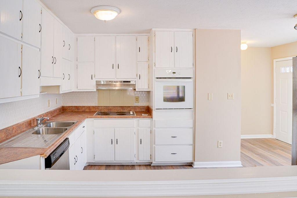 220 Winding Stream Trail Hampton, GA 30228 - Photo 9 of 35 a kitchen with a stove and white cabinets
