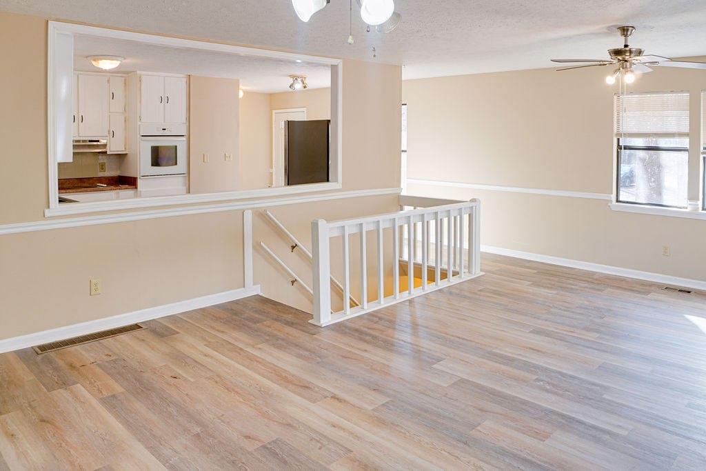 220 Winding Stream Trail Hampton, GA 30228 - Photo 10 of 35 wooden floor in an empty room with a window