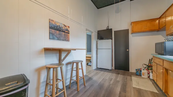 a very nice looking room with wooden floor and a workspace