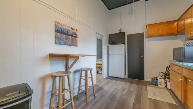 a very nice looking room with wooden floor and a workspace