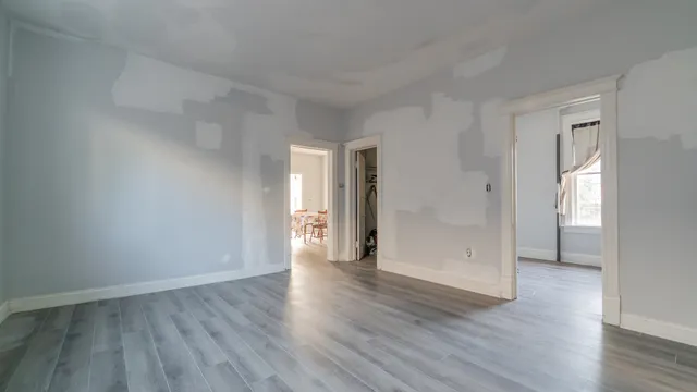 a view of an empty room and wooden floor
