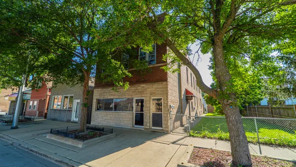 front view of a house with a tree