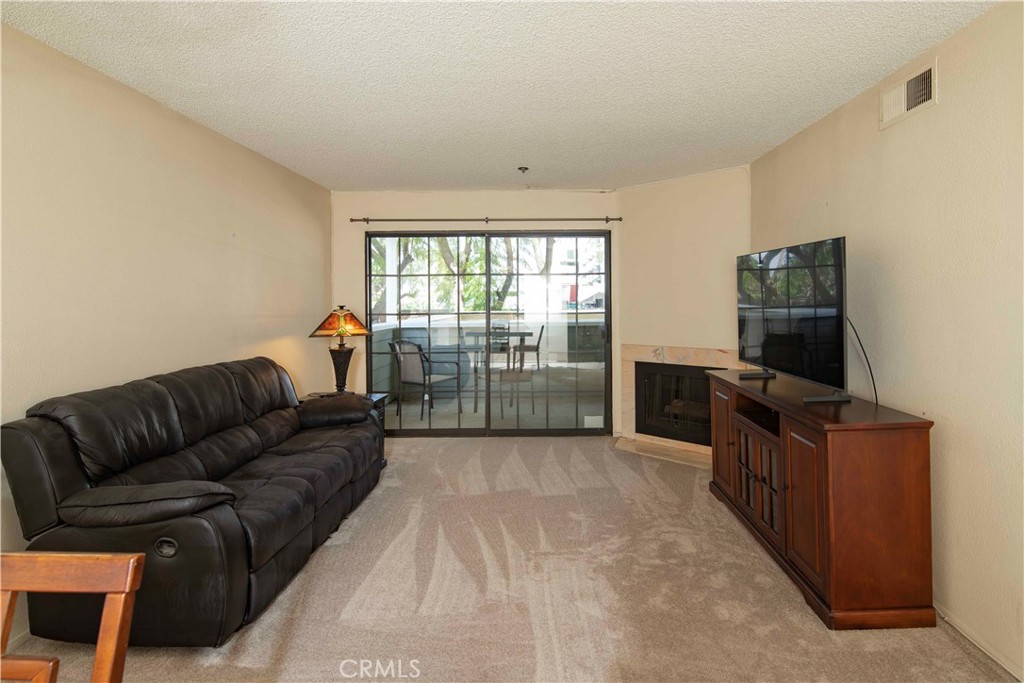 6545 Reseda Boulevard, Unit 8 Reseda, CA 91335 - Photo 11 of 24 a living room with furniture and a flat screen tv