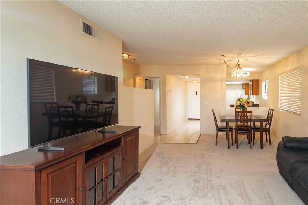 6545 Reseda Boulevard, Unit 8 Reseda, CA 91335 - Photo 12 of 24 a kitchen with stainless steel appliances kitchen island granite countertop a table and chairs in it