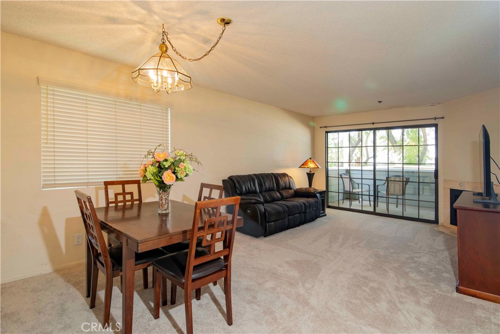 6545 Reseda Boulevard, Unit 8 Reseda, CA 91335 - Photo 13 of 24 a view of a dining room with furniture a chandelier and wooden floor