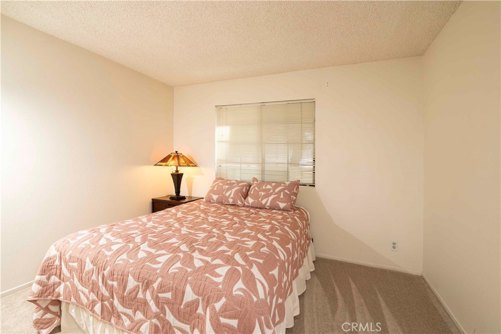 6545 Reseda Boulevard, Unit 8 Reseda, CA 91335 - Photo 15 of 24 a bedroom with a bed and a window