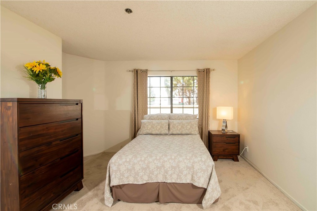 6545 Reseda Boulevard, Unit 8 Reseda, CA 91335 - Photo 17 of 24 a bedroom with a bed and window