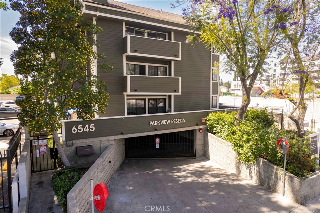 6545 Reseda Boulevard, Unit 8 Reseda, CA 91335 - Photo 2 of 24 a front view of a house with a yard and tree s