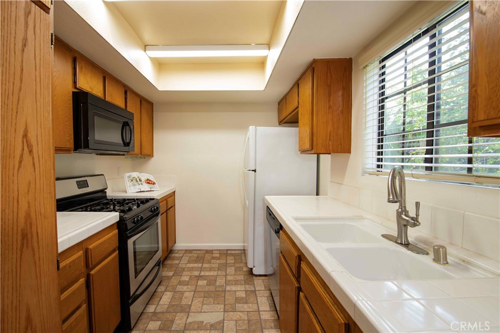 6545 Reseda Boulevard, Unit 8 Reseda, CA 91335 - Photo 8 of 24 a kitchen with stainless steel appliances granite countertop a sink and a stove