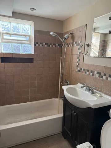 a bathroom with a sink mirror toilet and bathtub