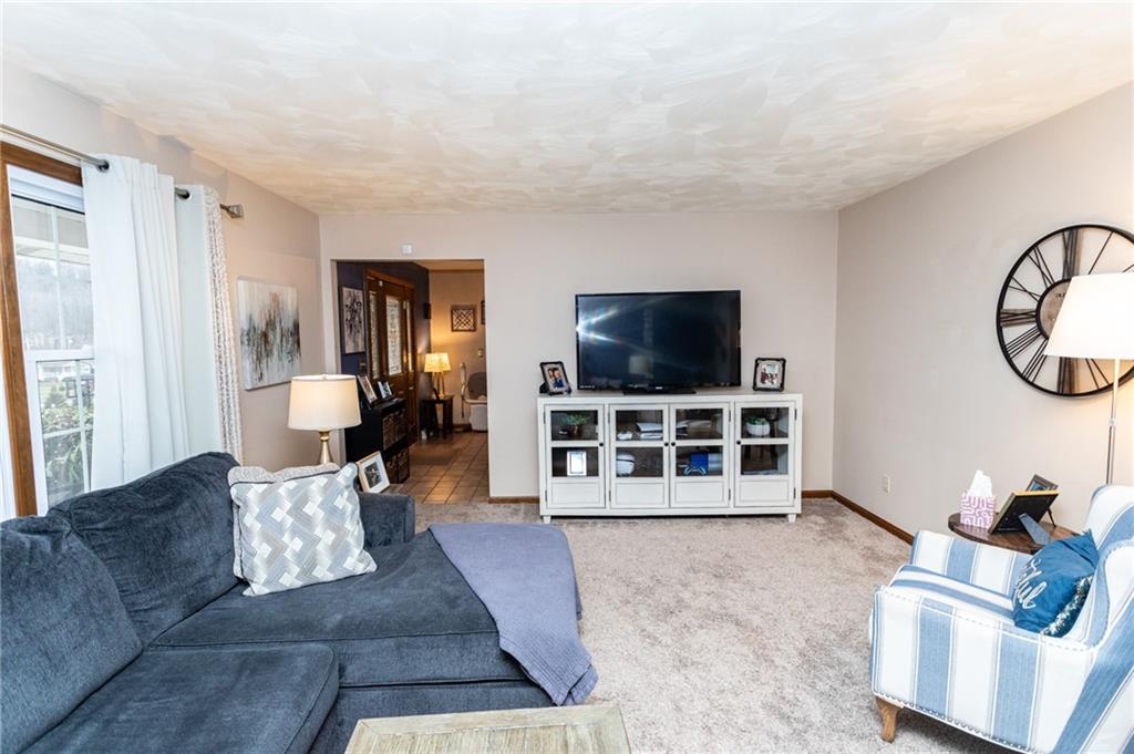 57 Russ Street Uniontown, PA 15401 - Photo 14 of 40 a living room with furniture and a flat screen tv
