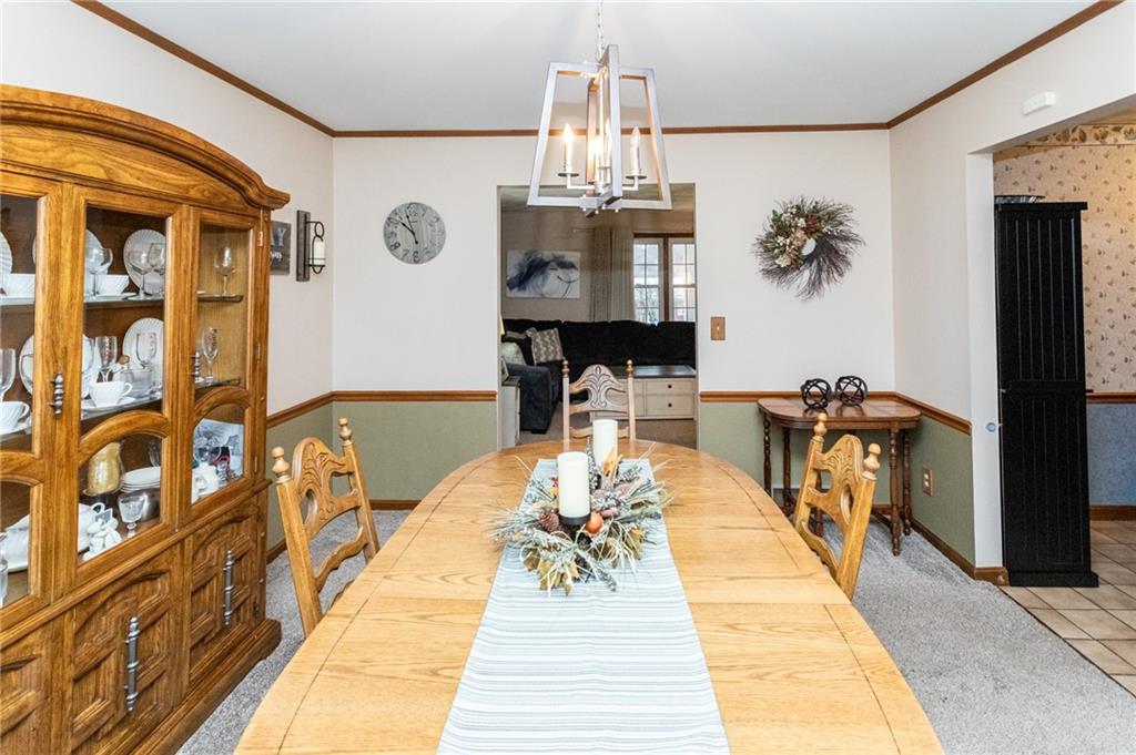 57 Russ Street Uniontown, PA 15401 - Photo 17 of 40 a dining room with chandelier and wooden floor