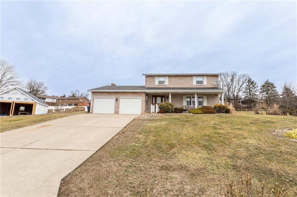 57 Russ Street Uniontown, PA 15401 - Photo 2 of 40 a front view of a house with a yard and garage