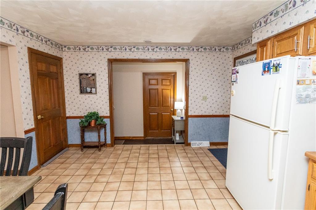 57 Russ Street Uniontown, PA 15401 - Photo 22 of 40 a room with a refrigerator and a table