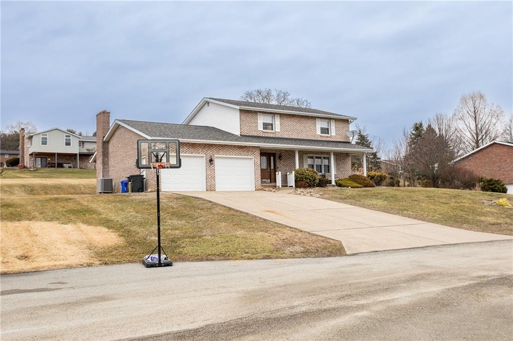 57 Russ Street Uniontown, PA 15401 - Photo 3 of 40 a front view of a house with a yard