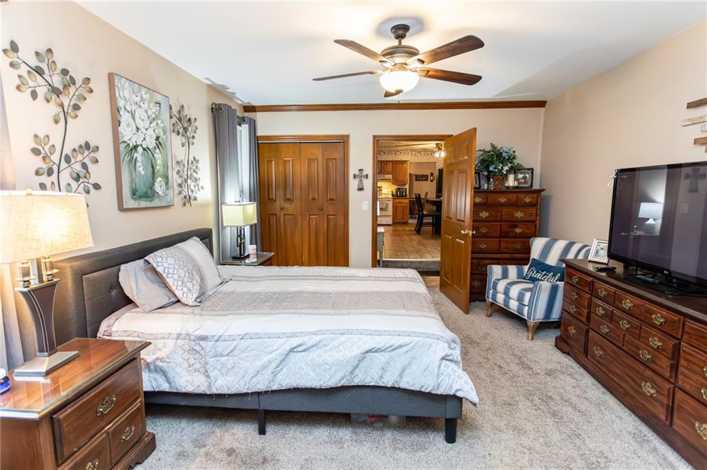 57 Russ Street Uniontown, PA 15401 - Photo 31 of 40 a bedroom with a bed and a chandelier