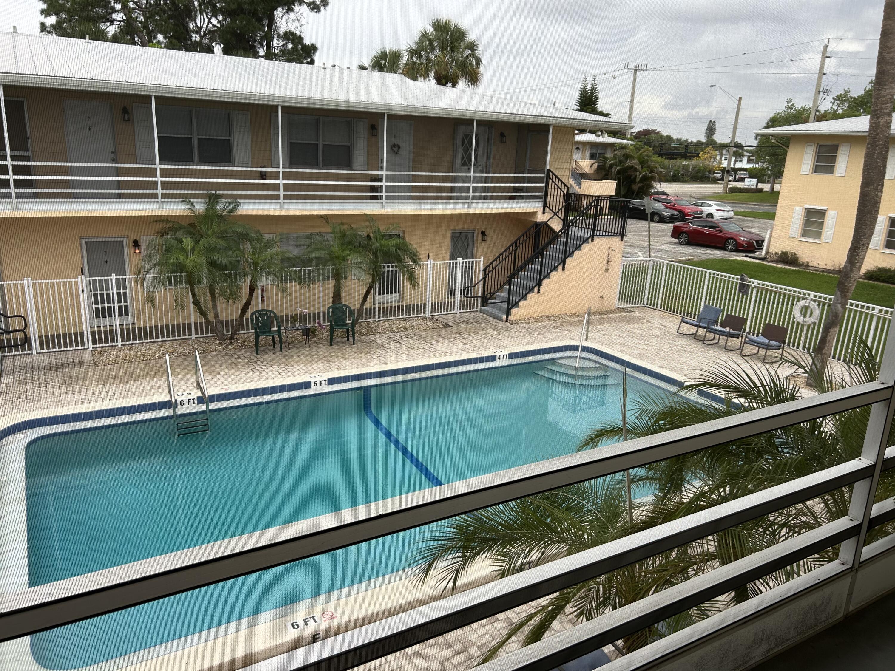 333 Southeast Martin Avenue, Unit 47 Stuart, FL 34996 - Photo 9 of 11 a view of a balcony with two chairs and a table