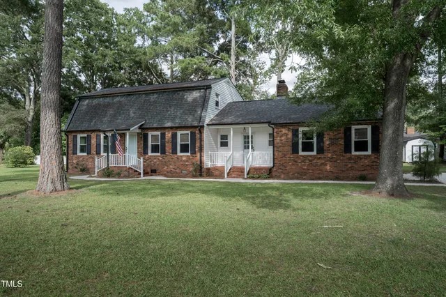 a front view of a house with a garden and porch