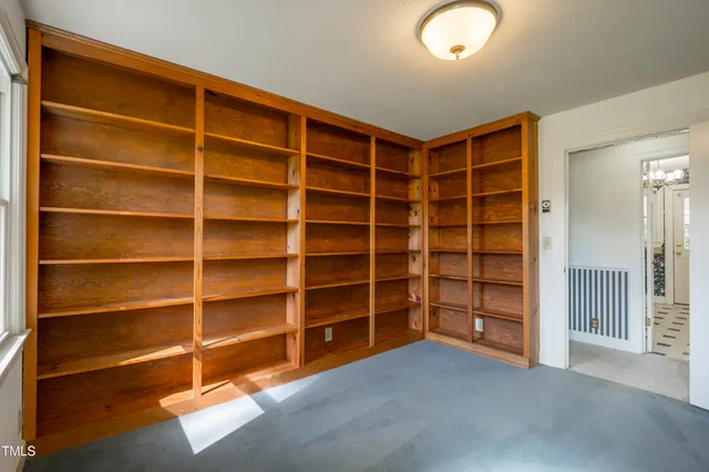 a view of an empty room with empty shelves