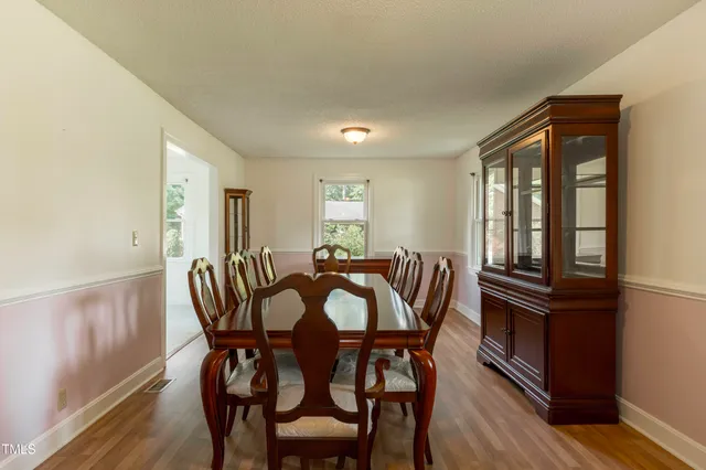 a view of a dining room with furniture and window