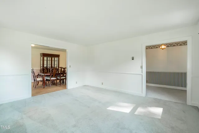 an empty room with furniture and a window