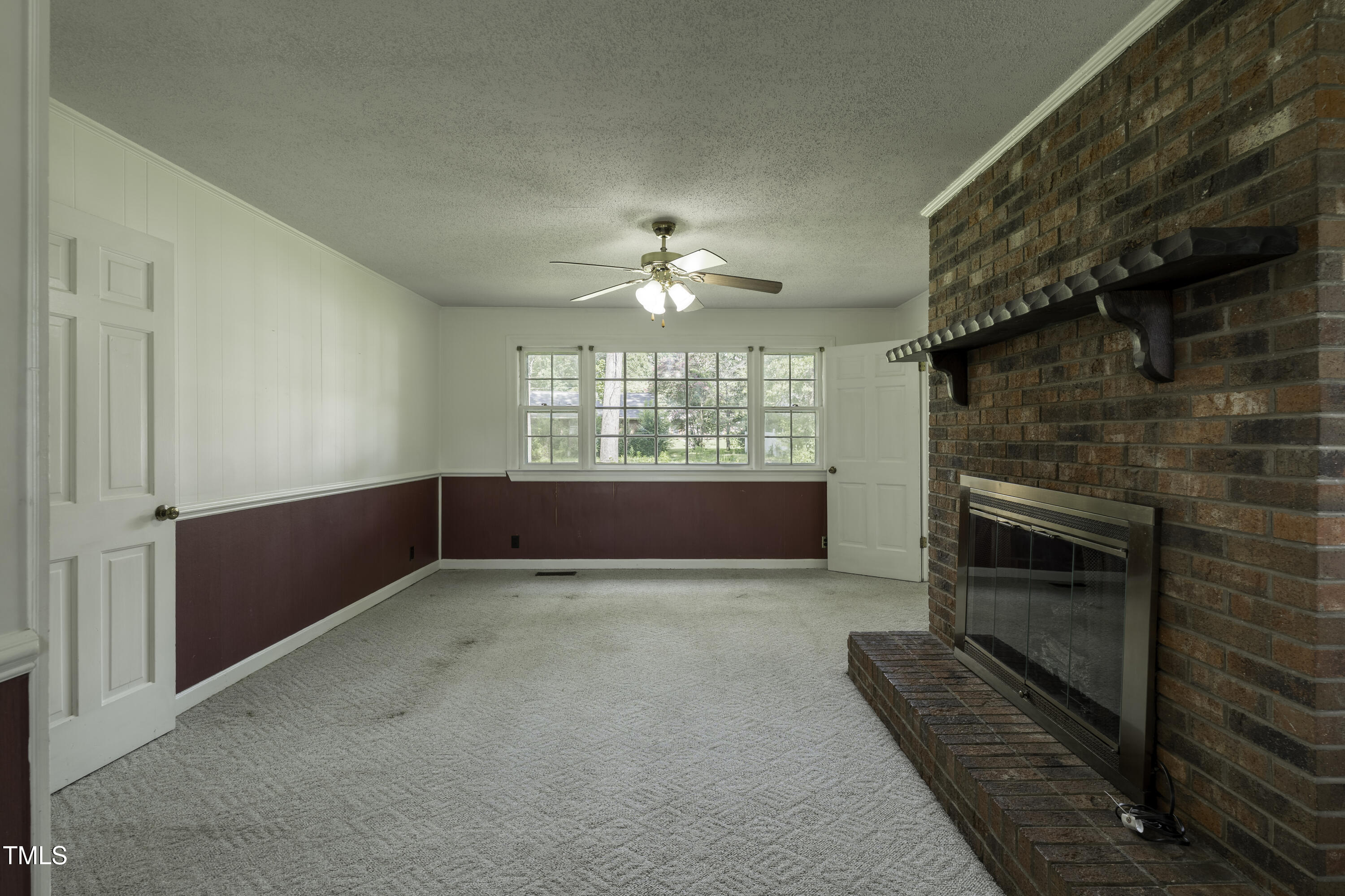 1604 Brunswick Drive Dunn, NC 28334 - Photo 2 of 43 a view of an empty room with a fireplace and a window