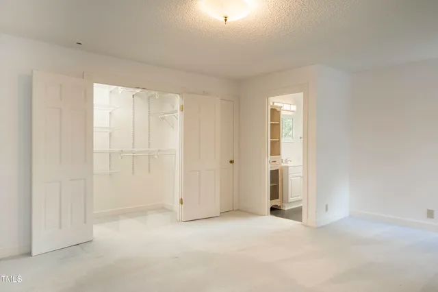a view of an empty room and closet area