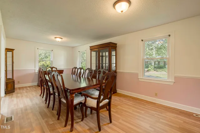 a dining room with furniture and wooden floor
