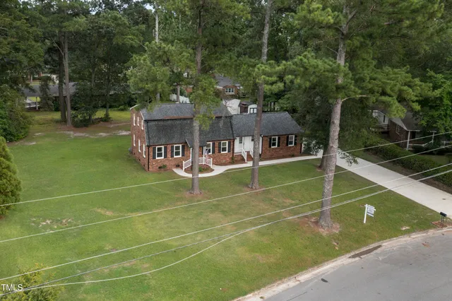 an aerial view of a house with a yard