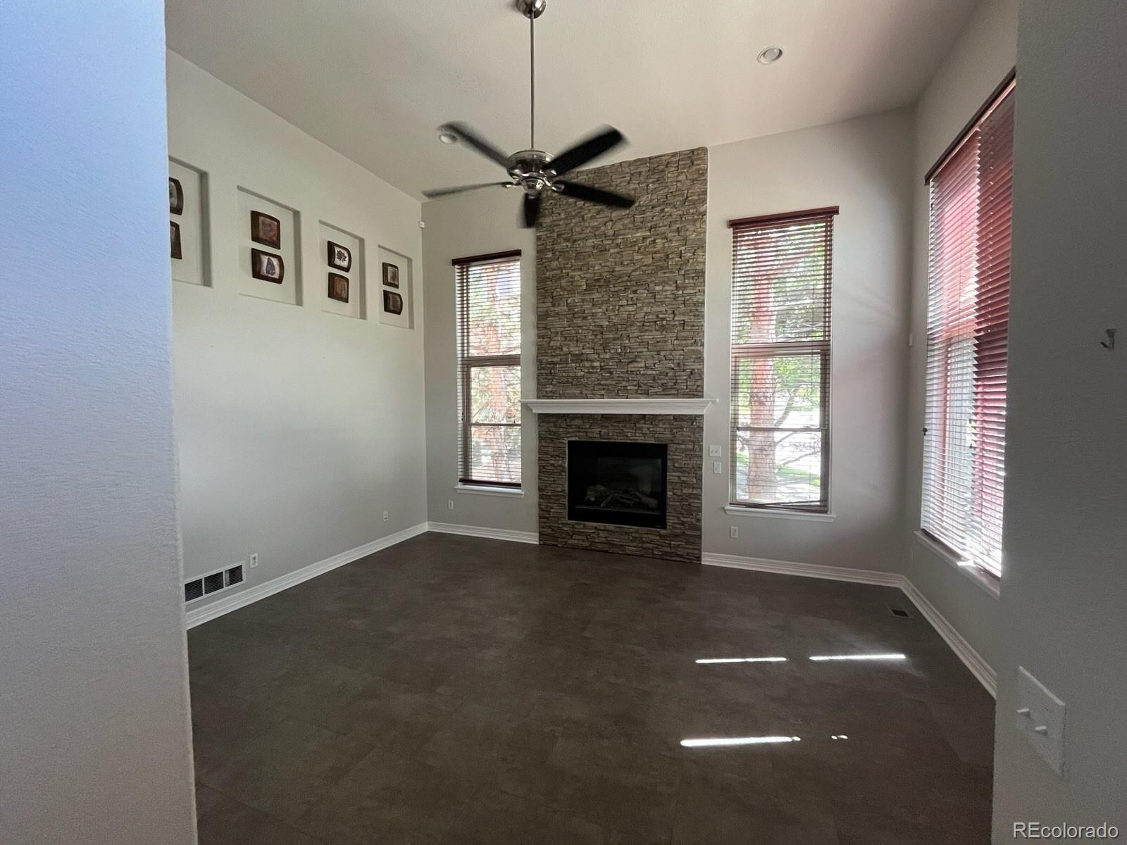 10158 RidgeGate Circle Lone Tree, CO 80124 - Photo 2 of 15 a view of an empty room with a fireplace and a window
