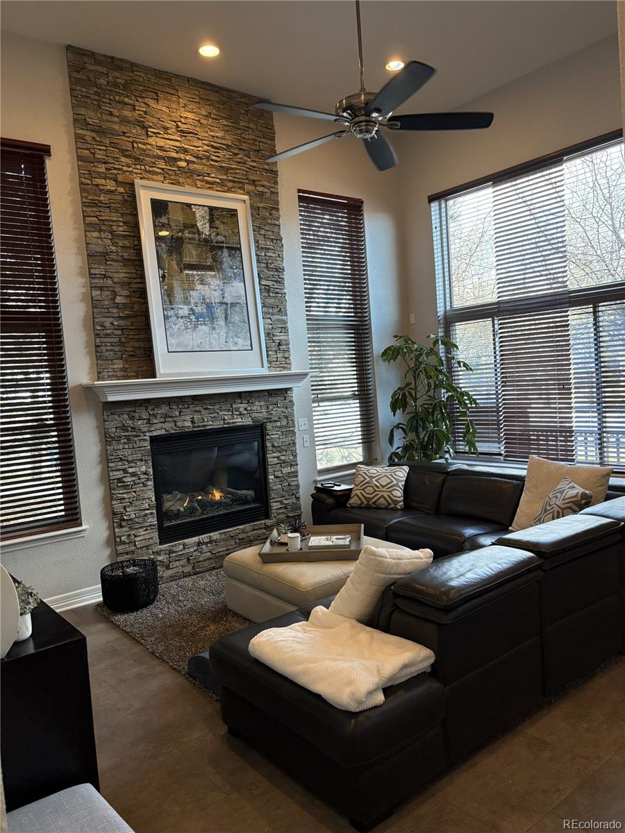 10158 RidgeGate Circle Lone Tree, CO 80124 - Photo 3 of 15 a living room with furniture and a fireplace