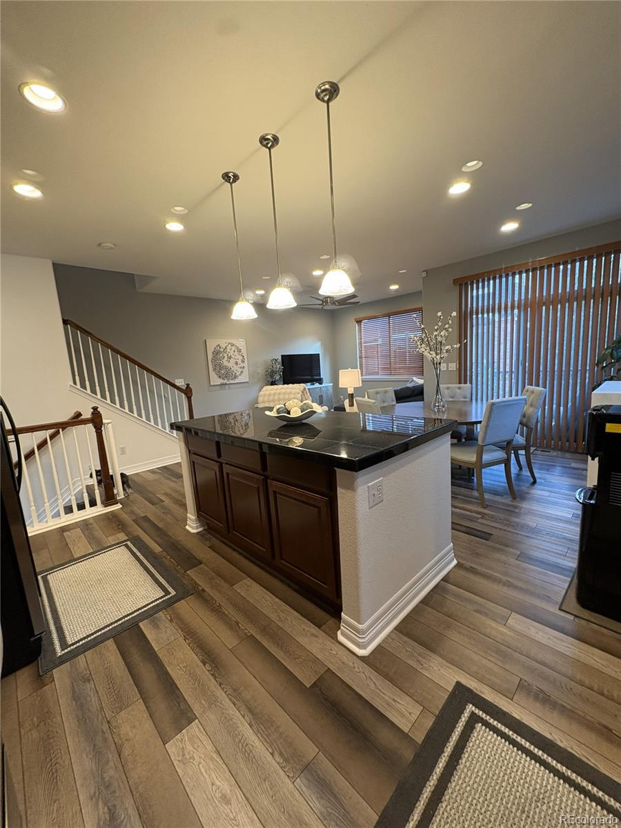10158 RidgeGate Circle Lone Tree, CO 80124 - Photo 8 of 15 a view of a living room and kitchen with stainless steel appliances granite countertop furniture