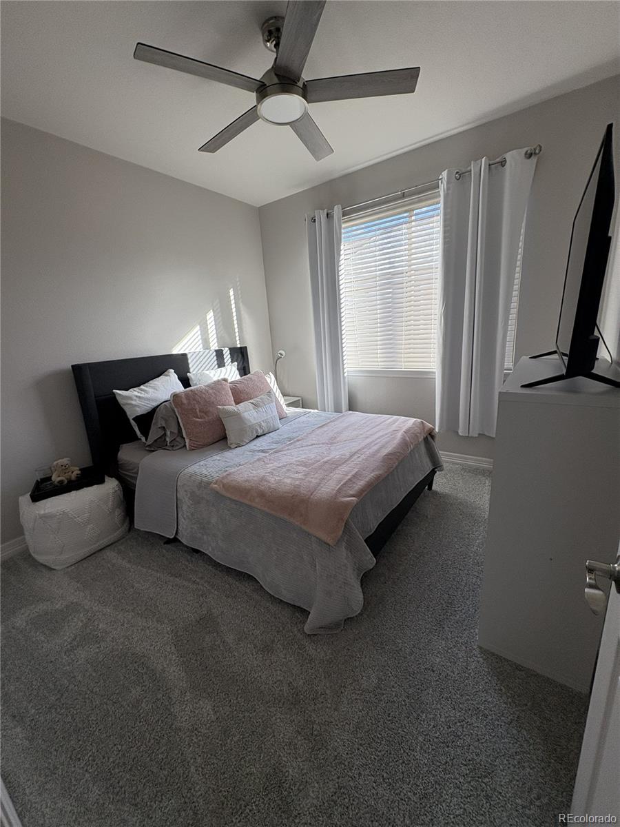 10158 RidgeGate Circle Lone Tree, CO 80124 - Photo 9 of 15 a bedroom with bed and window