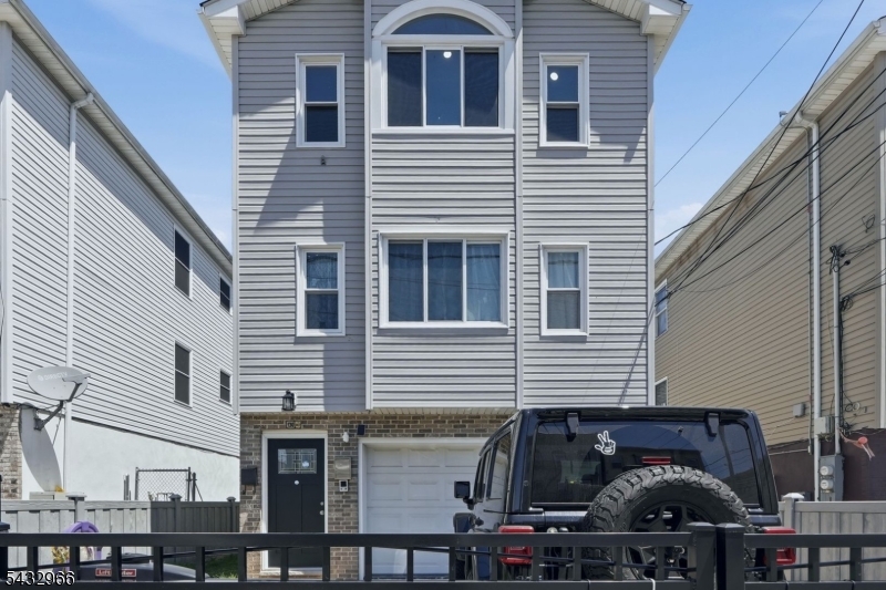 130 3rd Street, Unit 2 Passaic, NJ 07055 - Photo 9 of 12 a front view of a house with balcony