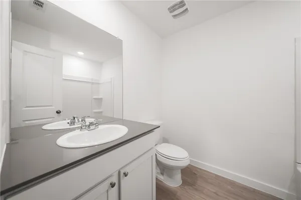 a bathroom with a sink toilet and mirror