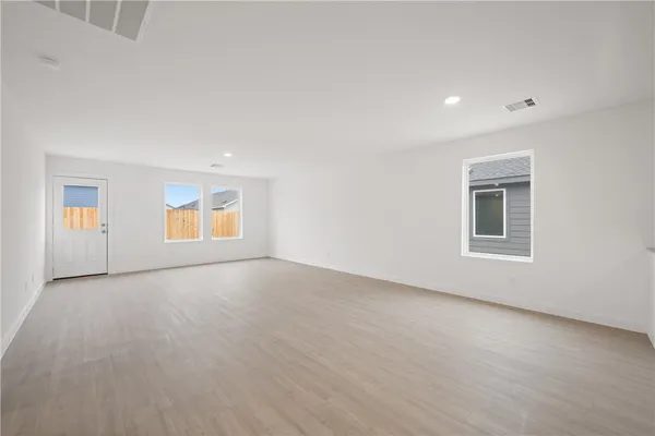 an empty room with windows and closet