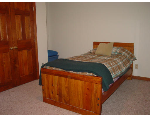 20 Pikes Hill Road Sterling, MA 01564 - Photo 13 of 16 a bed sitting in a bedroom next to a wooden door