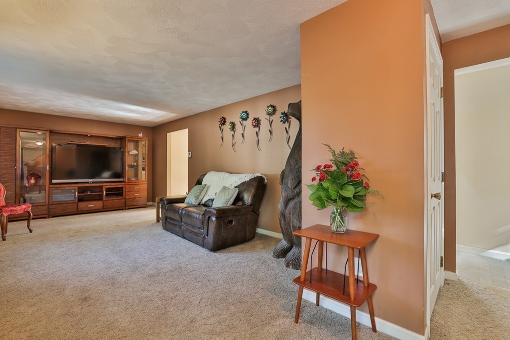 20 Patten Road Tewksbury, MA 01876 - Photo 12 of 29 a living room with furniture and a flat screen tv