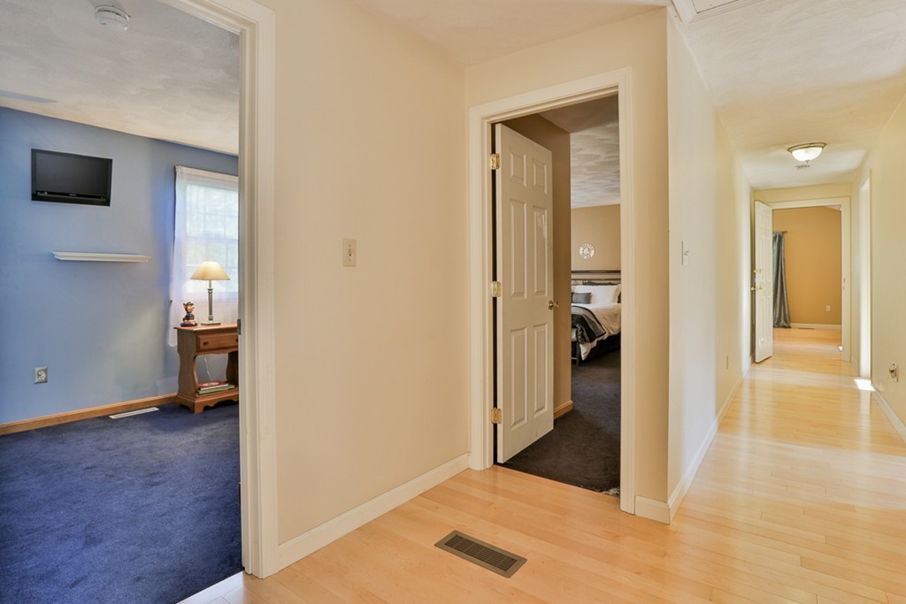 20 Patten Road Tewksbury, MA 01876 - Photo 16 of 29 a view of a hallway with wooden floor and a living room