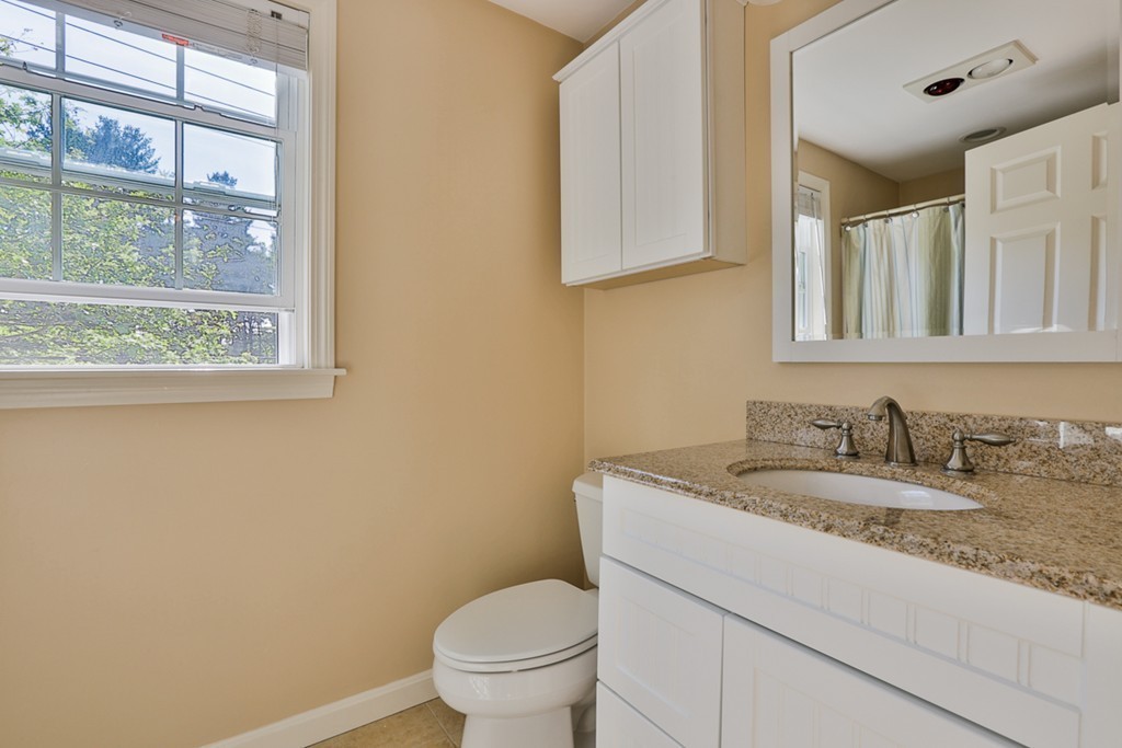20 Patten Road Tewksbury, MA 01876 - Photo 19 of 29 a bathroom with a granite countertop toilet sink mirror and a window