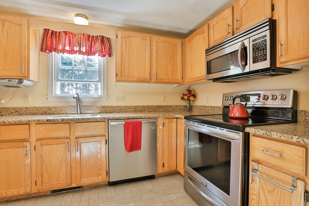 20 Patten Road Tewksbury, MA 01876 - Photo 3 of 29 a kitchen with granite countertop cabinets stainless steel appliances and window